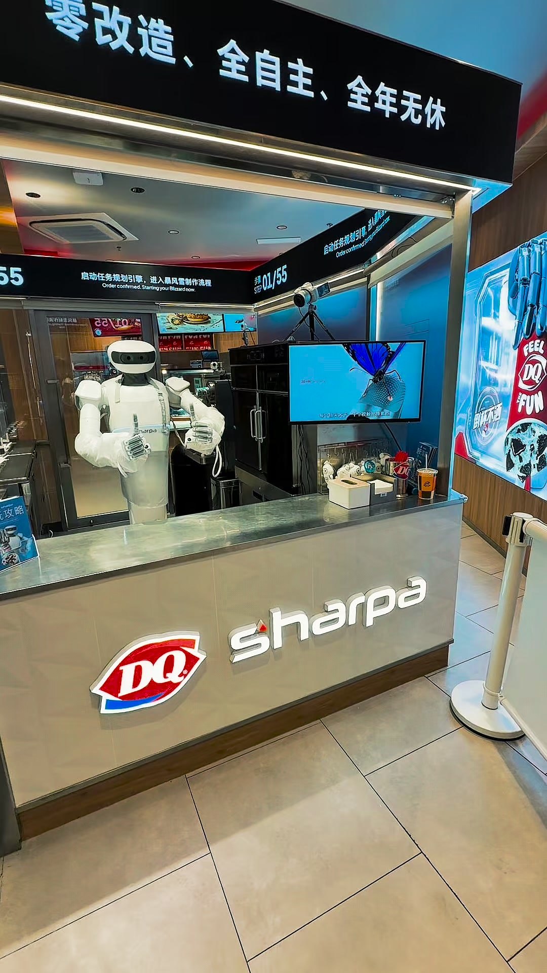 Sharpa humanoid at a Dairy Queen store in Shanghai, serving a customer order